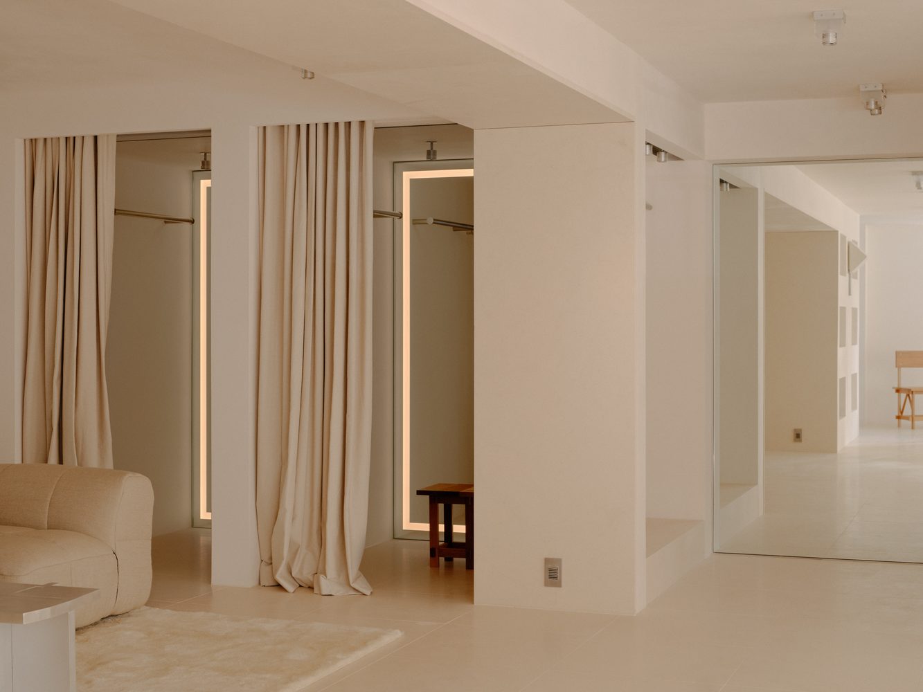 Linen curtain and travertine walls in a light-filled room