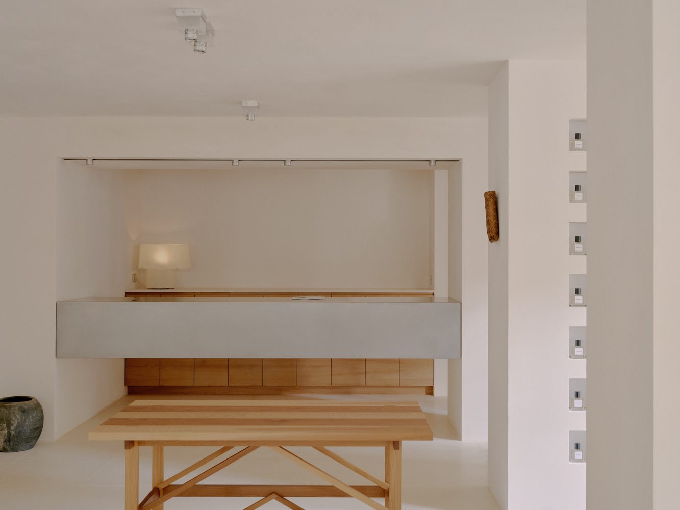 Timber trestle table against a stone wall