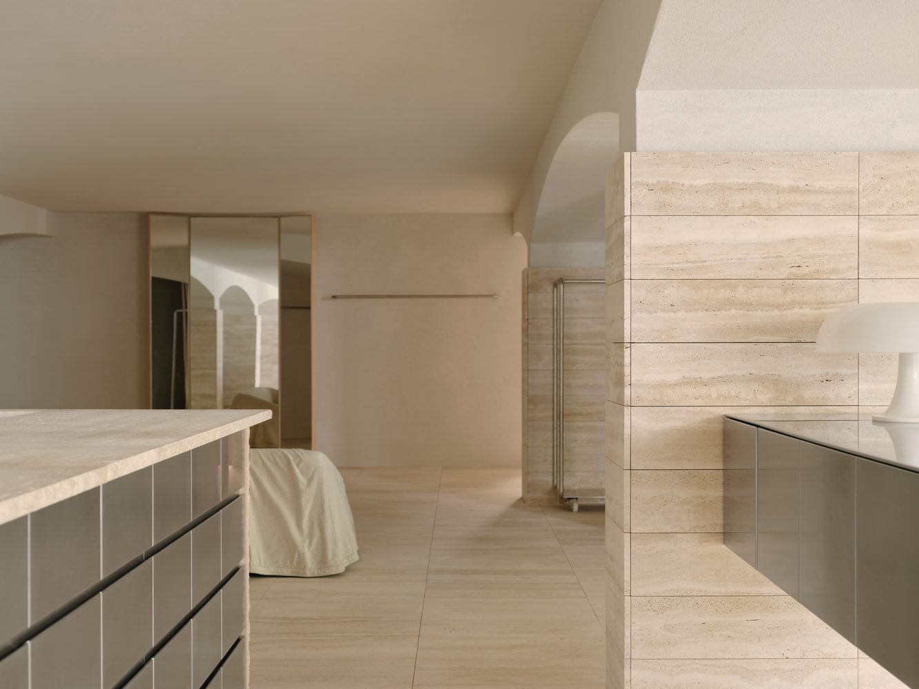 Arched white interior with travertine joinery