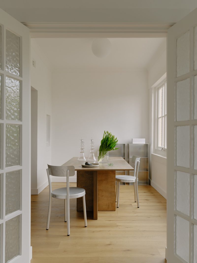 Dining nook with a white table and glass doors
