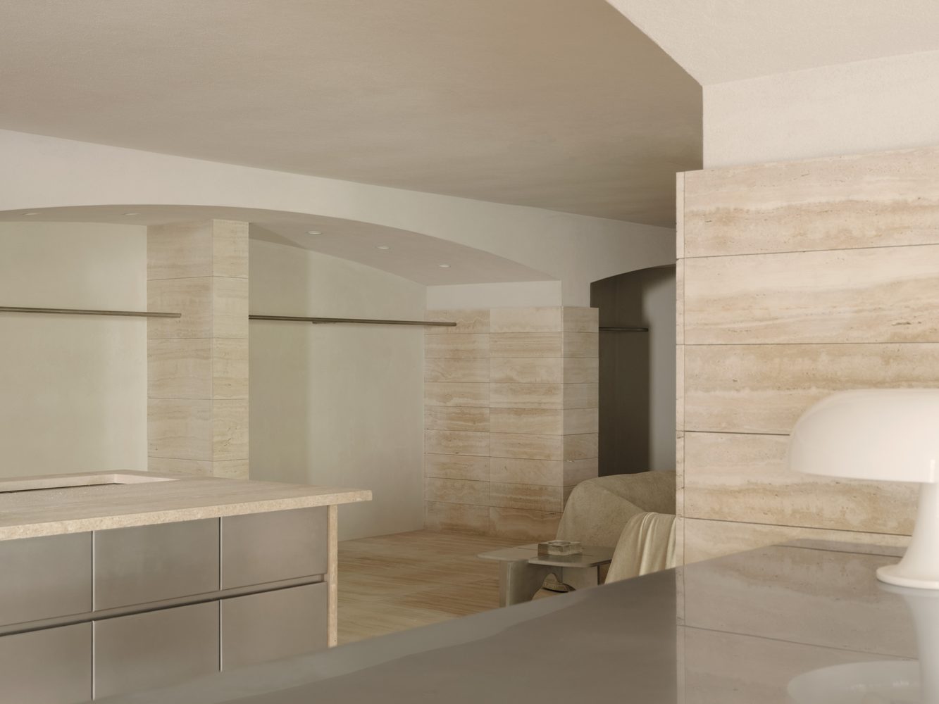 Travertine walls and a steel cabinet beneath an arch